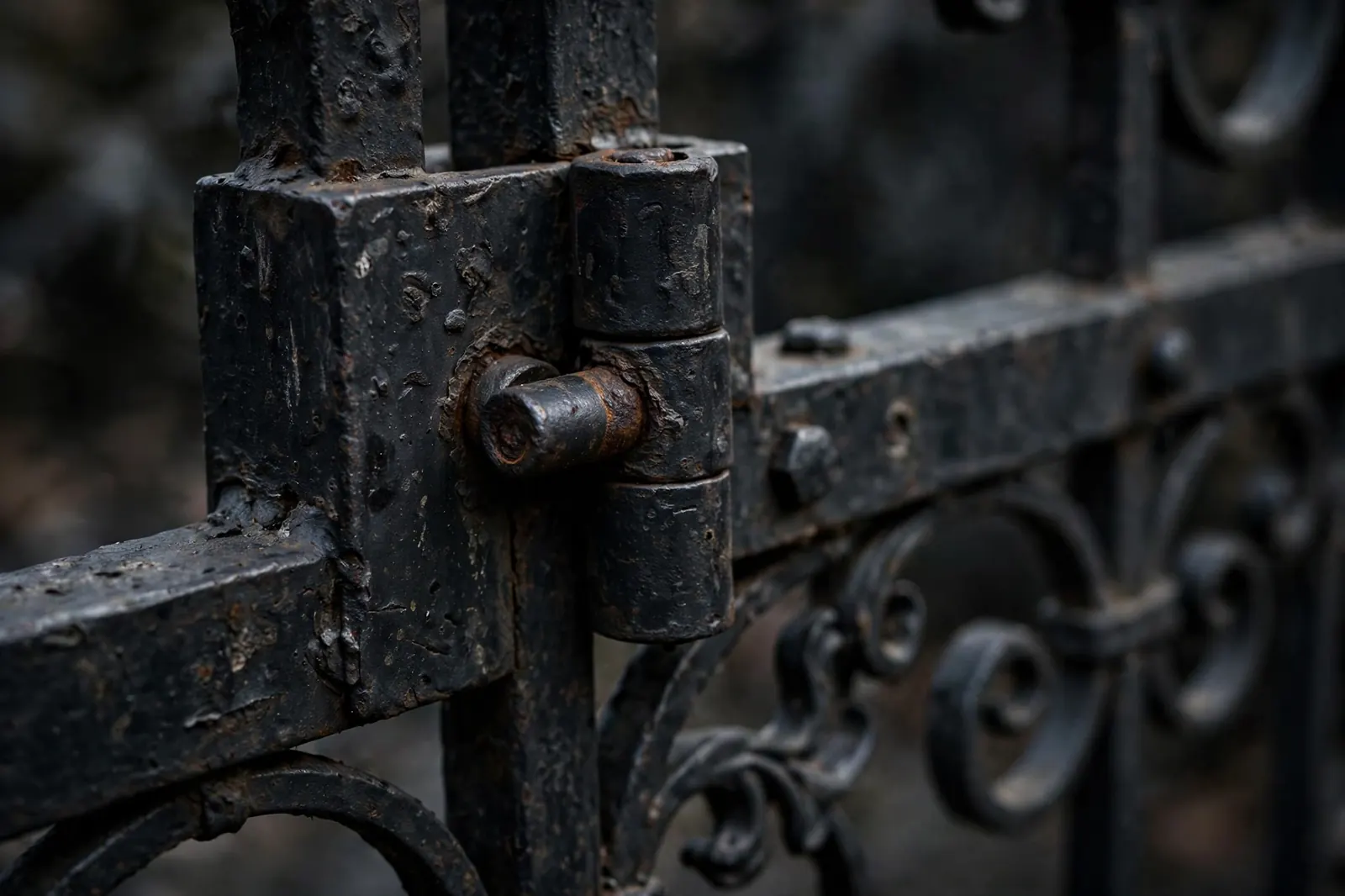 Close-up of a worn iron gate hinge, the part BS Gate Repair Service fixes